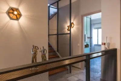 a home hallway with a wall light and a railing at Casa Maritima in Chania Town