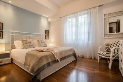 a bedroom with a bed and a window and a chair at Villa Oleander in Kounoupidhianá