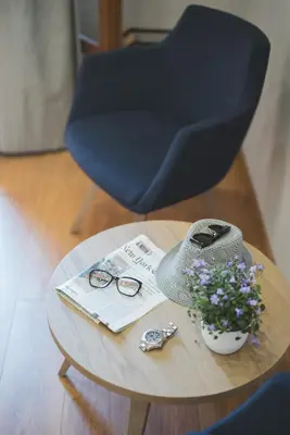 a table with a chair and glasses and a vase of flowers at Bluebell Luxury Suites in Chania Town