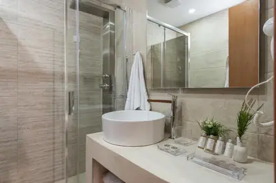 a bathroom with a sink and a shower at Bluebell Luxury Suites in Chania Town