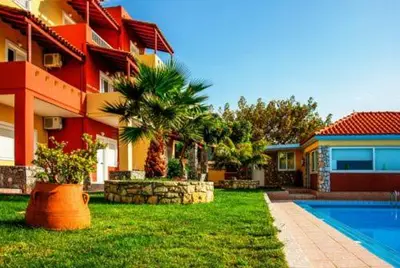 a house with a yard with a swimming pool at Eliros Studios in Stalos