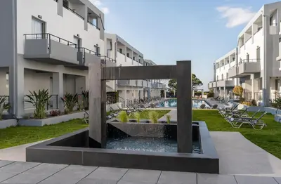 a fountain in the courtyard of a building at Sunrise Village Hotel - All Inclusive in Plataniás