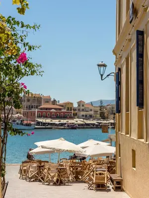 a group of tables and umbrellas next to the water at Casa Alba Seaview House in Chania Town