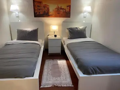 a room with two beds and a table with a lamp at Casa Alba Seaview House in Chania Town