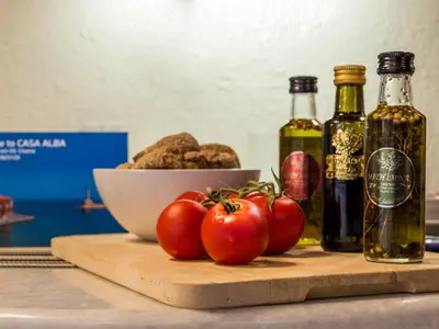 a table with a bowl of nuts and tomatoes on a cutting board at Casa Alba Seaview House in Chania Town