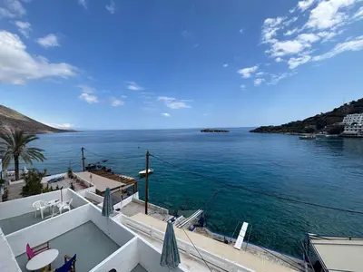 a view of the ocean from a house at Scirocco Rooms in Loutro