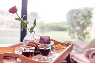 a table with a tray of food and two glasses of wine at Lavender Villas Chania in Agia Marina Nea Kydonias