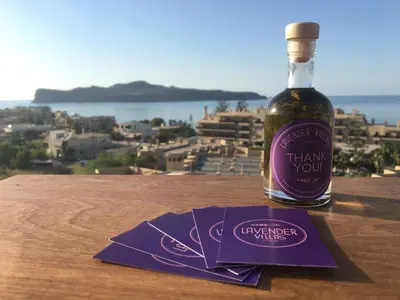 a bottle of wine sitting on top of a table at Lavender Villas Chania in Agia Marina Nea Kydonias