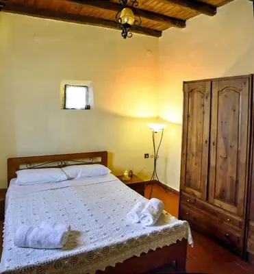 a bedroom with a bed with towels on it at Elia House in Megála Khoráfia