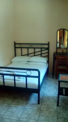 a bedroom with a bed and a table and a mirror at Constantinos Studios in Chania Town