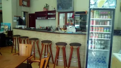 a bar with a row of stools in a restaurant at Constantinos Studios in Chania Town
