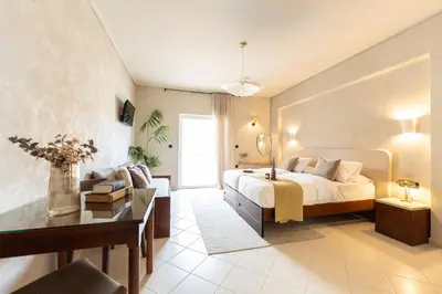 a large bedroom with a bed and a desk at Joanna's Place in Palaiochóra