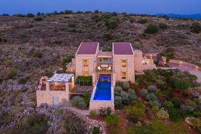 an aerial view of a house with a swimming pool at Kaminia Villa in Makhairoí