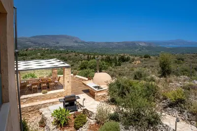 a view of a patio with a table and chairs at Kaminia Villa in Makhairoí