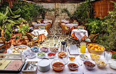 a table with plates and bowls of food on it at Hotel Ideon in Chania Town