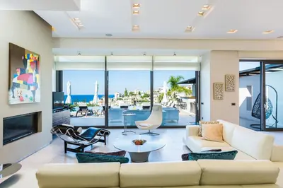 a living room with a couch and a table at Winehill Villa in Plataniás