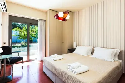 a bedroom with a bed with two towels on it at Winehill Villa in Plataniás