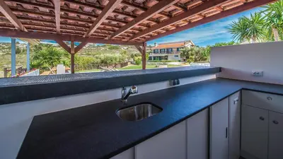 a kitchen with a sink and a view of a house at Villa Mathea in Kounoupidhianá