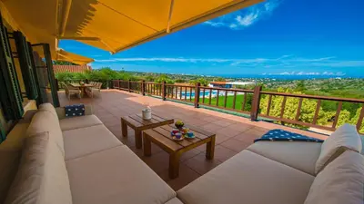 a patio with a couch and a table on a balcony at Villa Mathea in Kounoupidhianá