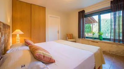 a bedroom with a large white bed and a window at Villa Mathea in Kounoupidhianá