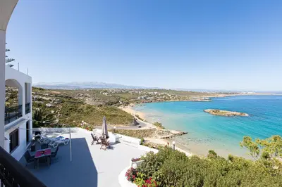 a view of the beach from the balcony of a house at Kalathas Sunset Villa in Kalathas