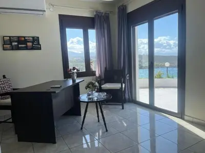 an office with a desk and a table with a chair at Kalathas Sunset Villa in Kalathas
