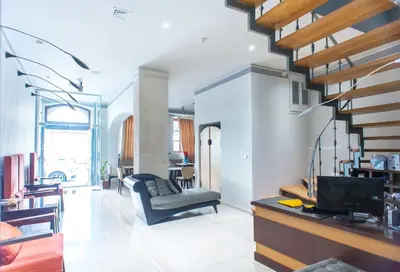 a living room with a couch and a staircase at Splanzia Boutique Hotel in Chania Town