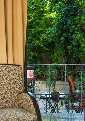a chair sitting in front of a window at Splanzia Boutique Hotel in Chania Town