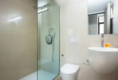 a bathroom with a shower and a toilet and a sink at Splanzia Boutique Hotel in Chania Town