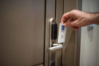a hand is holding a temperature card on a refrigerator at Splanzia Boutique Hotel in Chania Town