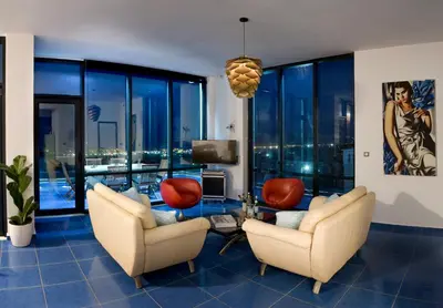 a living room with two chairs and a table and a tv at Villa Emanuele in Gerani Chanion
