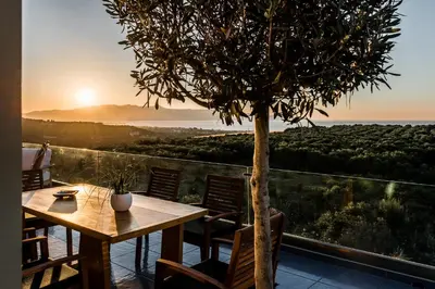 a table and chairs on a patio with a tree at Villa Emanuele in Gerani Chanion