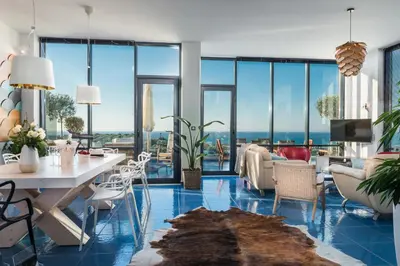 a living room with blue floors and large windows at Villa Emanuele in Gerani Chanion