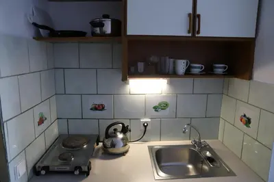 a kitchen counter with a sink and a tea kettle at Aris Apartments in Gerani Chanion