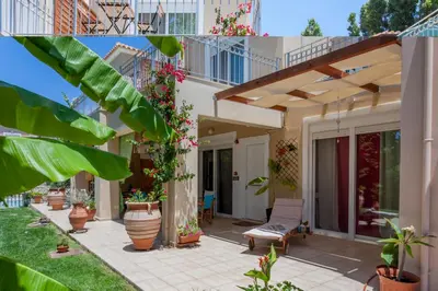 a house with a patio with potted plants at Cretamos Seaside Villas in Kissamos