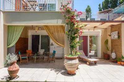 a patio with potted plants and a table at Cretamos Seaside Villas in Kissamos