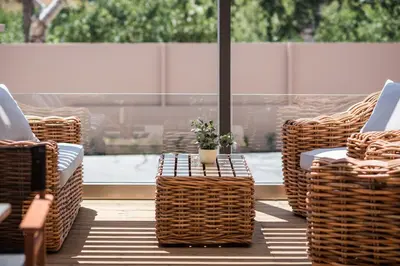 a group of wicker chairs and a table with a plant at Sea & City Apartments in Chania Town