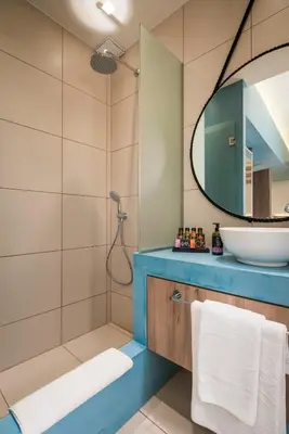 a bathroom with a sink and a mirror at Sea & City Apartments in Chania Town