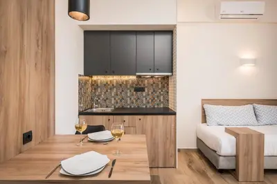 a room with a bed and a table with glasses of wine at Sea & City Apartments in Chania Town