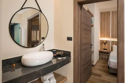 a bathroom with a sink and a mirror at Sea & City Apartments in Chania Town