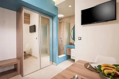 a living room with a television and a table with bananas at Sea & City Apartments in Chania Town