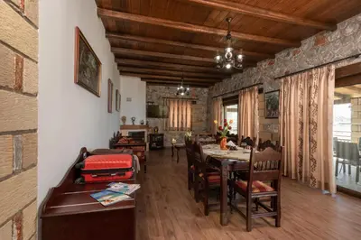 a dining room with a table and chairs at Sunset Traditional House in Ravdhoúkha