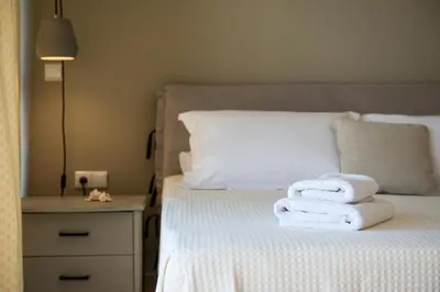 a bed with towels stacked on top of it at Villa Ismini in Kato Daratso