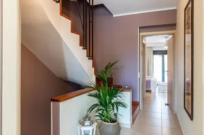 a hallway with a staircase with a plant at Villa Ismini in Kato Daratso