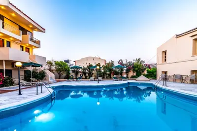 a pool at a hotel with blue water at Orestis Hotel Sea View Apartments in Stalos