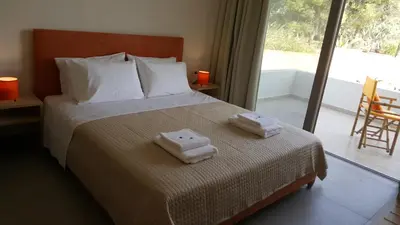 a bedroom with a bed with two towels on it at Sea Queen Villa in Kato Daratso