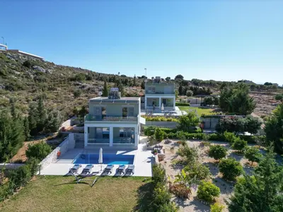 an aerial view of a large house with a pool at Κatakis Villas in Agios Onoufrios
