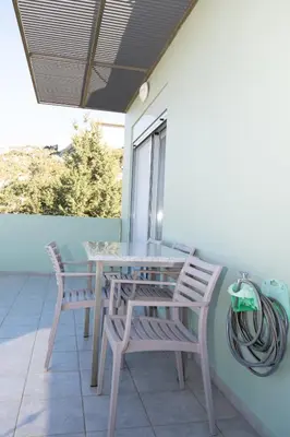 a table and two chairs on a porch at Κatakis Villas in Agios Onoufrios