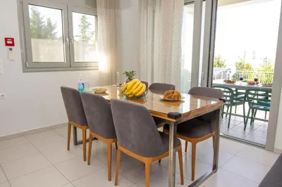 a dining room table with a bunch of bananas on it at Κatakis Villas in Agios Onoufrios