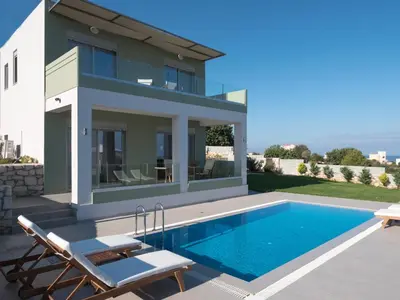a villa with a swimming pool and a house at Κatakis Villas in Agios Onoufrios